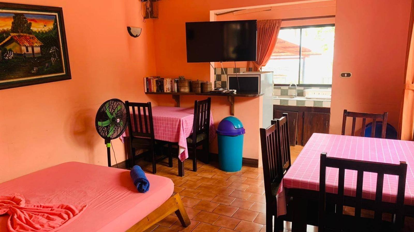Dining area with two tables and a kitchen in the apartment